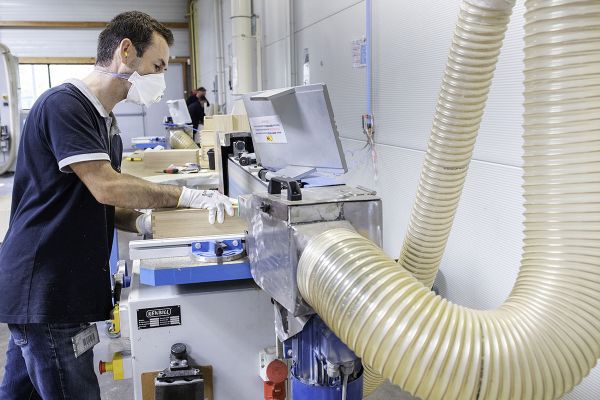 Travail sur une ponceuse à bande équipée d'un système d'aspiration des poussières